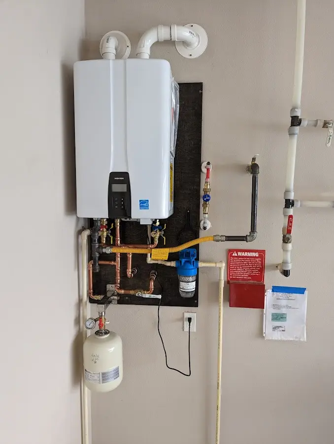 Professional plumber installing copper piping in a Colorado City home